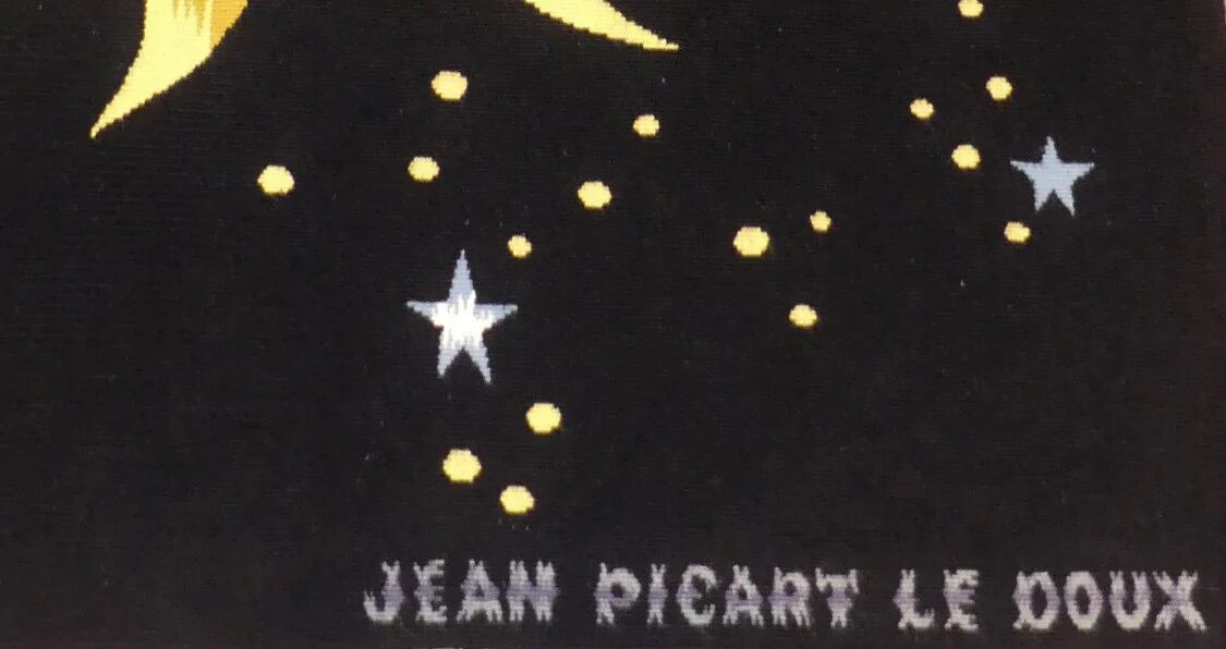 Signature JEAN PICART LE DOUX tissée en lettres claires dans la lisière basse, parmi les étoiles